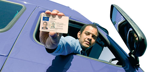 Driver holding out his Driver Qualification Card