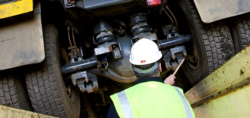 DVSA vehicle examiner under a lorry