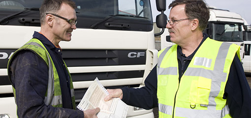 Vehicle examiner passing a lorry after test