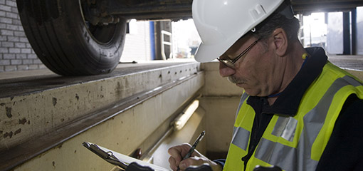 Vehicle tester completing paperwork