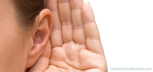 Woman with a hand to her ear showing she is listening
