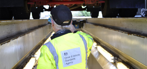 DVSA vehicle inspector underneath a lorry