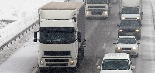 Lorries and cars on a snowy road