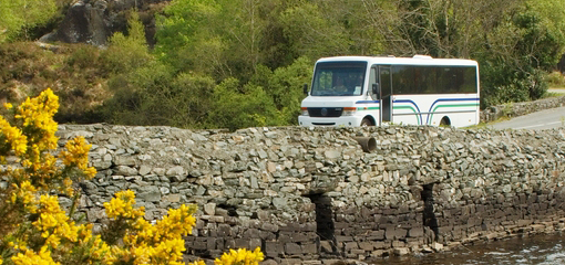 Bus driving over rural bridge