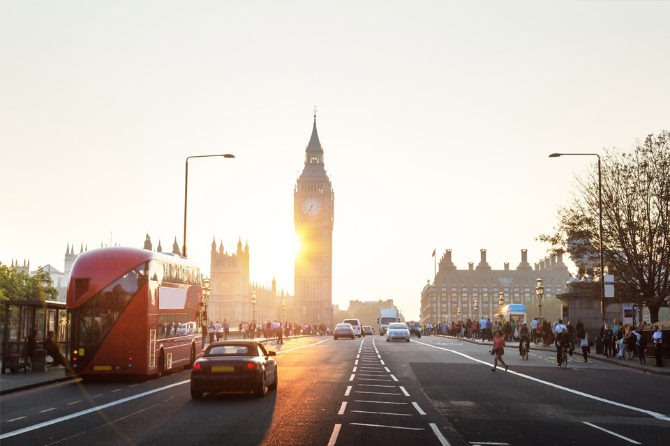 London road scene showing red bus and Big Ben