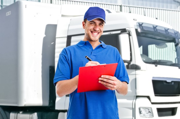 Man with clipboard next to a lorry