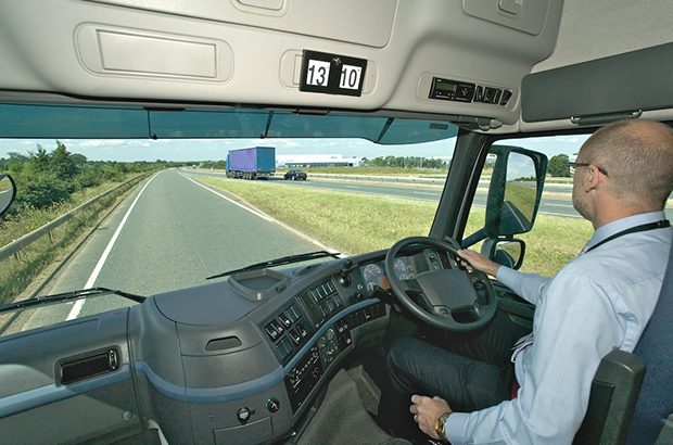 Lorry driver inside cab changing gear