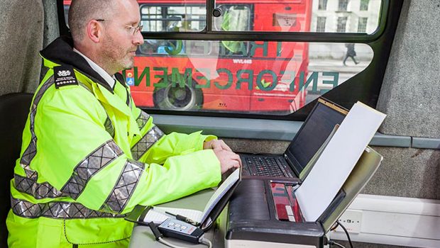 A man at computer checking vehicle records