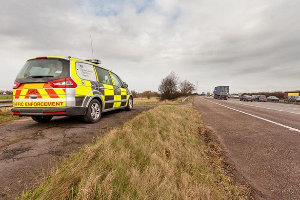 A DVSA enforcement vehicle sits by the roadside