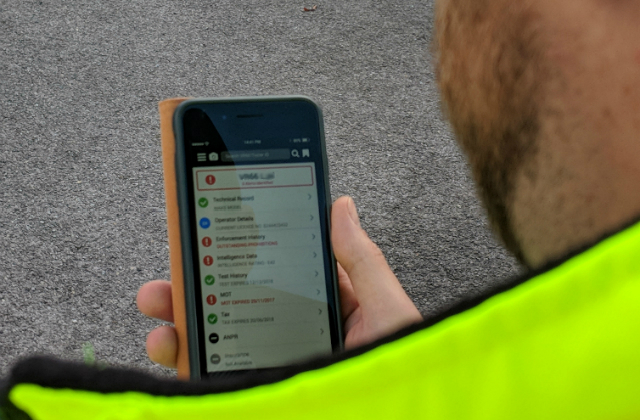 Enforcement officer looking at mobile phone