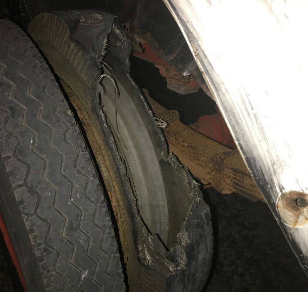 An old tyre that has completely failed, leaving a gaping hole showing the interior of the tyre.