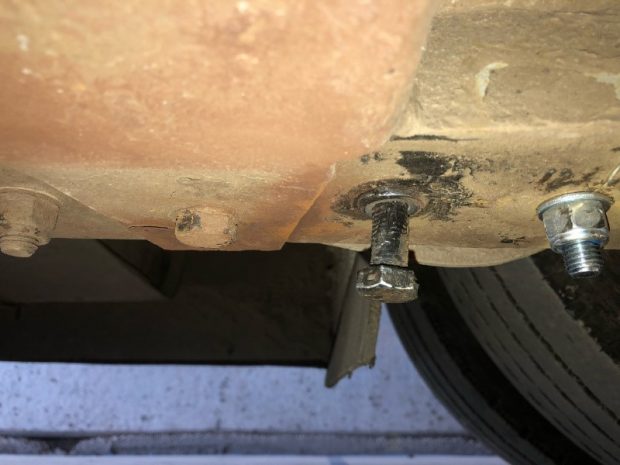 a bolt holding the rear passenger side suspension leaf spring in place being fixed in by glue.