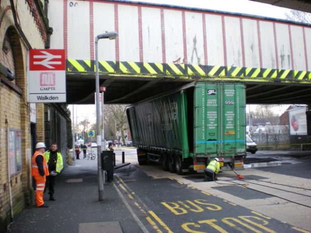 a lorry stuck under a bridge