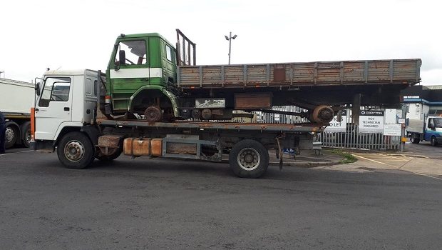 Overloaded truck carrying another truck