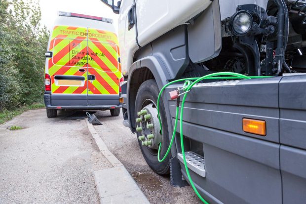 Cable tied lorry with enforcement van in view