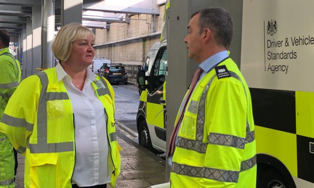 DVSA Enforcement Delivery Manager Della Read talks to a colleague