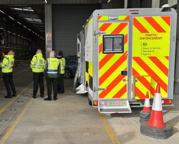 Members of DVSA walking members around an ATF, with a DVSA van in the foreground.