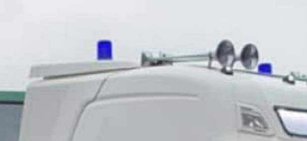 an image of the top of an HGV which has blue flashing lights attached. 